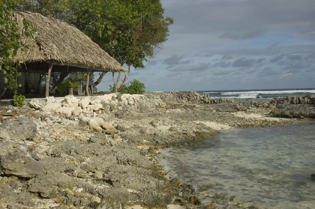 A coastal home standing beside the ocean in Tarawa, Kiribati